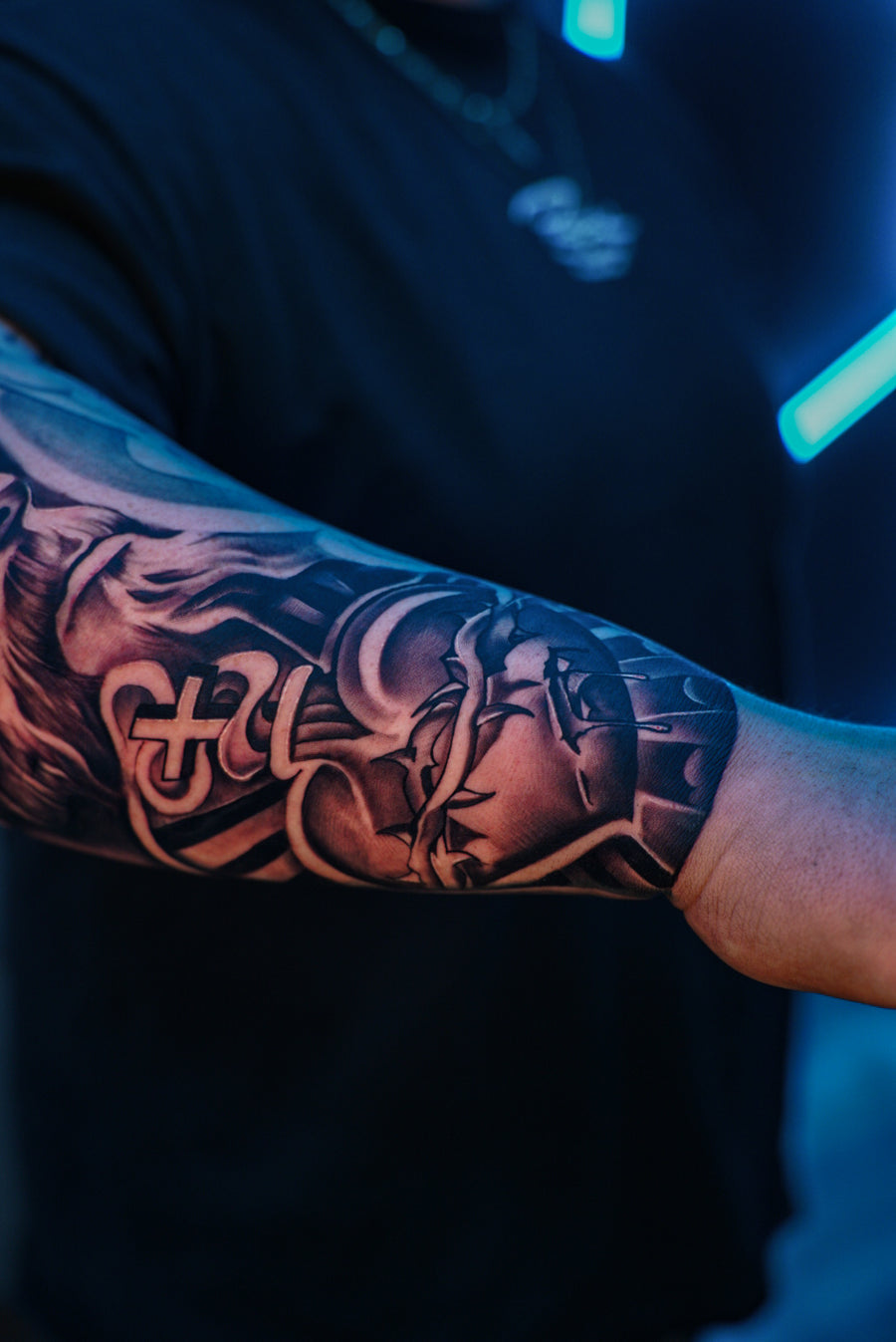 Black and grey lettering forearm tattoo