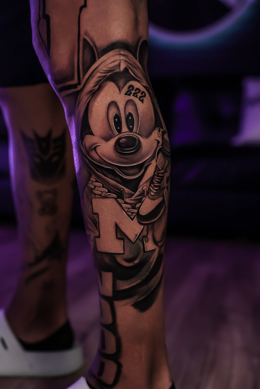 Black and grey cartoon character leg tattoo