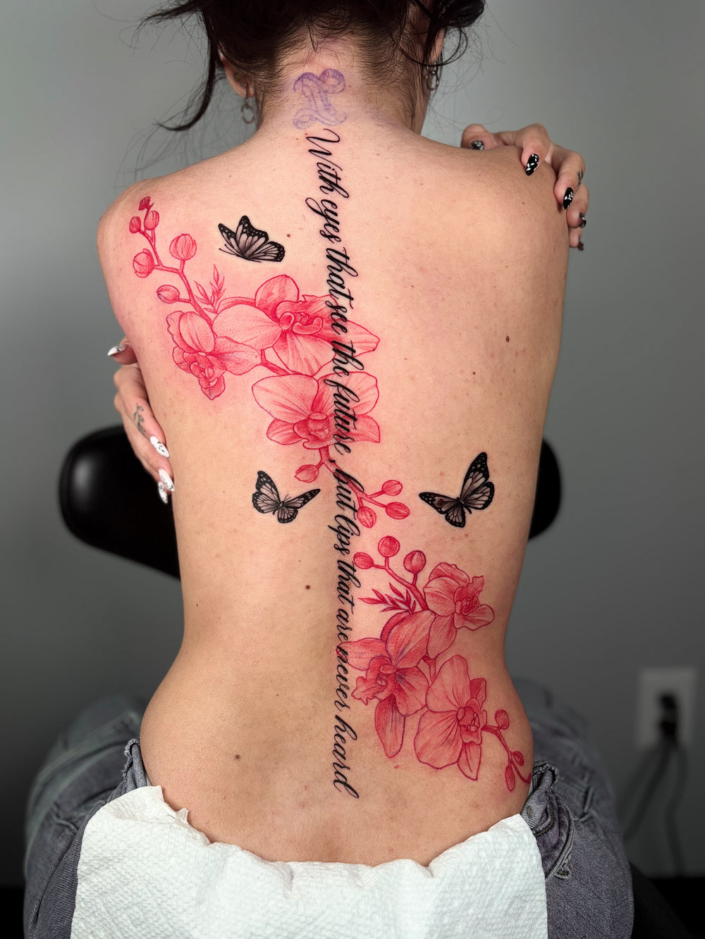 Color back tattoo with cherry blossoms, butterflies and script lettering