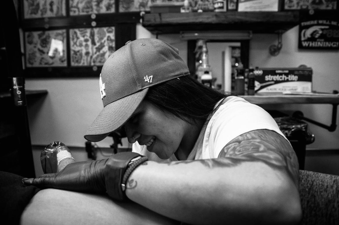 Tattoo artist at work on a client at the Tagz Tattoo studio in Mesa, AZ