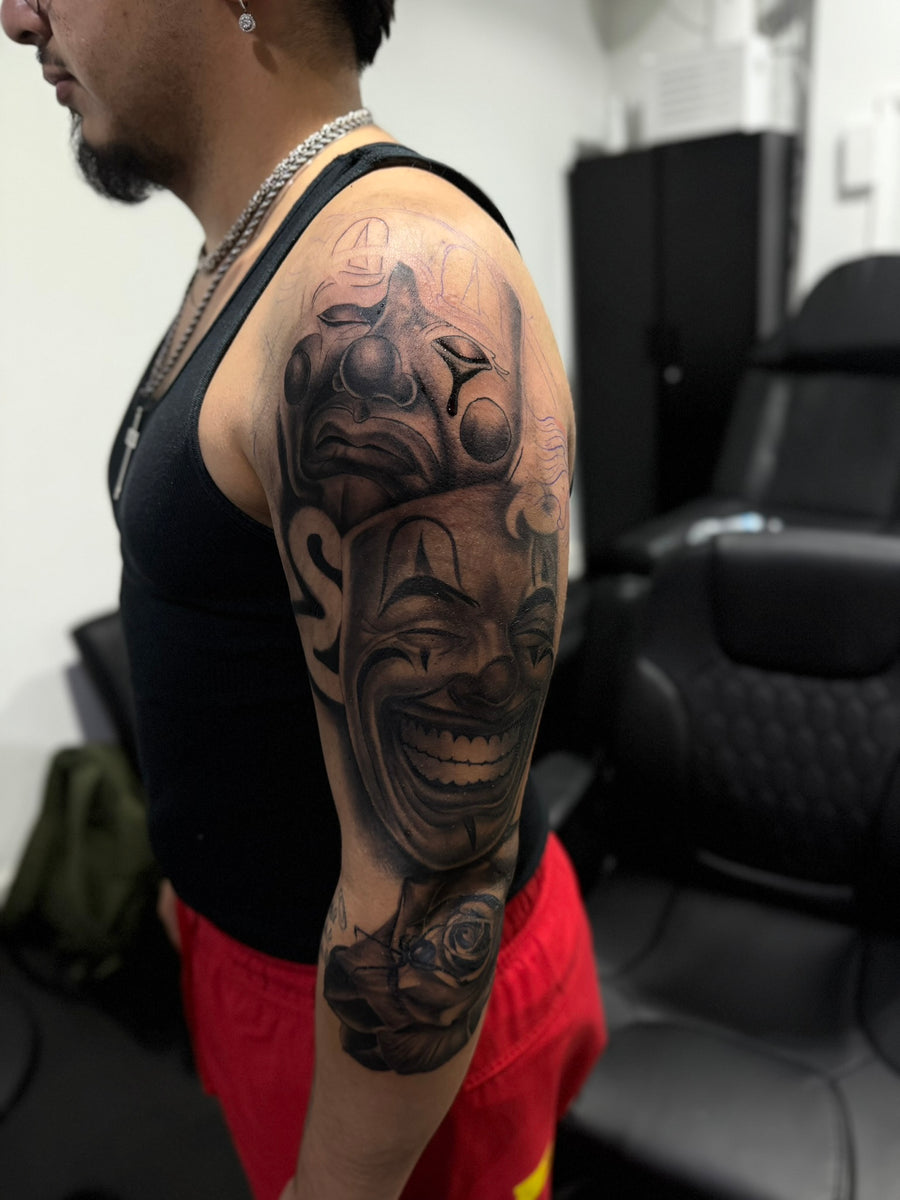 Smile now cry later sleeve tattoo at Tagz Tattoo