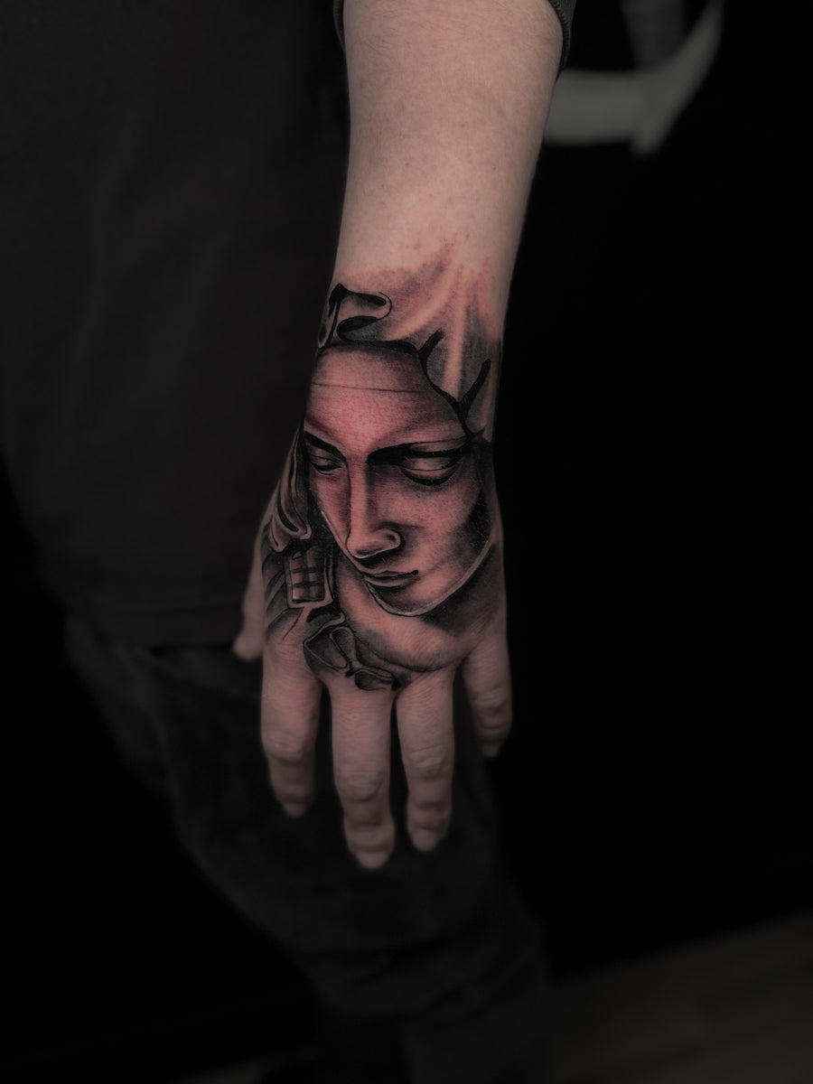 Black and grey portrait hand tattoo