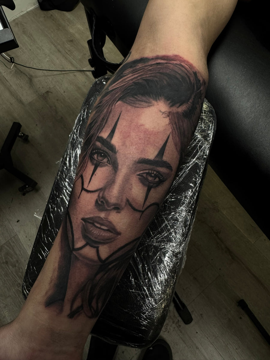 Black and grey clown girl portrait on the forearm, fresh from the chair at Tagz Tattoo in Mesa, AZ