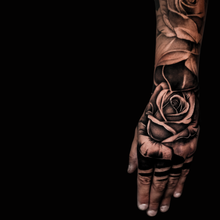 Black and grey rose hand and forearm tattoo by Tagz Tattoo, Mesa AZ